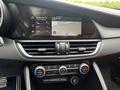 A 2023 Alfa Romeo Giulia interior showcasing a sleek dashboard with a digital display and climate control knobs