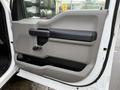 Interior door panel of a 2017 Ford F-350 SD featuring a textured surface a handle and a control for window operation