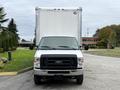 A 2019 Ford Econoline van in front view with a large white box truck trailer attached
