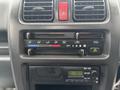 Dashboard controls of a 2008 Suzuki Carry featuring climate control buttons and a radio display