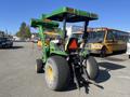 A green 2008 John Deere 3320 tractor with a 300X loader and large rear tires positioned facing away from the viewer