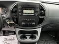 Interior dashboard of a 2020 Mercedes-Benz Metris featuring audio controls and dual cup holders