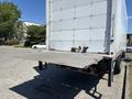 A 2020 Hino 338 truck with a flat loading dock at the rear featuring a foldable ramp for easy loading and unloading