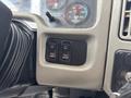 Control panel of a 2013 International WorkStar featuring three switches labeled for fog lights, fan, and an override function
