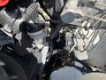 Close-up view of a 2010 Mercedes-Benz Sprinter engine showcasing various components such as hoses wires and a connector