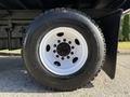 A close-up view of a white wheel and black tire from a 2017 Ford F-650 Super Duty vehicle