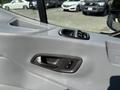 Close-up view of the door panel of a 2016 Ford Transit 150 featuring a window control and a locking mechanism