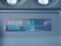 A digital display showing the text "ENGINE IDLE" and "HOURS 6705" on a dashboard of a 2011 Ford F-550