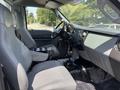 Interior view of a 2015 Ford F-750 showcasing two gray seats and a dashboard with various controls and a gearshift in the center console