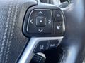Close-up of the steering wheel controls of a 2018 Toyota Highlander featuring buttons for navigation audio and cruise control