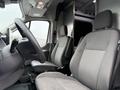Interior of a 2022 Ford Transit with two front seats visible and a steering wheel in the foreground