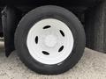 Close-up of a white rim and tire from a 2012 International TerraStar showing the wheel design and tire tread pattern