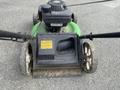 Three Honda Lawnboy mowers and two Stihl line trimmers arranged in a row on a flat surface
