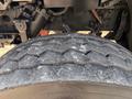 Close-up of a worn tire from a 2016 Freightliner M2 106 showcasing visible tread wear and cracks on the surface