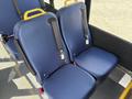 Two blue seats with seatbelts inside a vehicle, featuring yellow handles for easy access