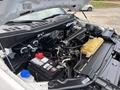 A 2020 Ford F-150 engine with visible components including the battery a coolant reservoir and various engine parts under the hood