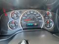 Dashboard of a 2022 GMC Savana displaying speedometer fuel gauge and various warning lights with a digital odometer reading 99650 km
