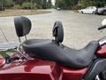A 2009 Harley-Davidson Road King with a black leather seat featuring a backrest and chrome accents