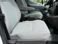 Front seats of a 2017 Ford Transit with gray upholstery and armrests