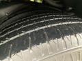Close-up of a tire from a 2015 Chevrolet Express featuring tread patterns and a textured surface