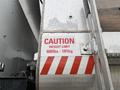 Red and white caution sign displaying weight limit of 400lbs 181kg on a metal surface of a 2011 International 7500 truck