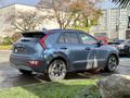 A blue 2023 Kia Niro EV parked with its rear visible showcasing a sporty design and distinctive taillights