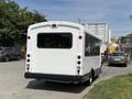 A white 2017 Chevrolet Express van with a rear door and multiple red brake lights