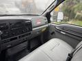 Interior view of a 2006 Ford F-450 showing the dashboard and front seat with controls and features clearly visible