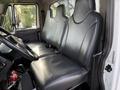 Interior of a 2012 International DuraStar 4300 showing two large leather seats with a steering wheel in the foreground