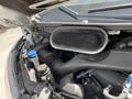 Close-up view of the engine compartment of a 2019 Ford Transit showing the air intake and various engine components with hoses and fluid reservoirs