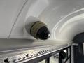 A dome camera mounted on the ceiling of a vehicle