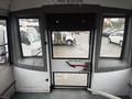 Interior view of a 2021 Ford Econoline showing a door with a red handle and large windows on either side