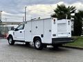 A white 2017 Ford F-350 SD truck with a service body featuring compartments on the sides and a rear access door