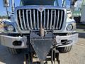 Front view of a 2014 International 7400 truck featuring a metallic grille and a visible front attachment point for equipment or trailers