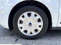 Close-up of a silver wheel with a unique spoke design on a 2021 Ford Transit Connect showing the tire branding and tread pattern