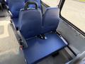 A blue seat interior of a 2020 Chevrolet Express with armrests and a seatbelt