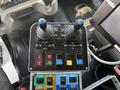Control panel featuring joystick controls and buttons for functions like body lift plow operation and auger with labels for power and various controls