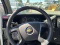 Steering wheel and dashboard of a 2013 Chevrolet Express with various gauges and controls visible