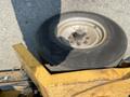Top view of a tire mounted on a wheel from a 2010 Vermeer Corporation BC1200XL machine with visible wear and rust on the rim