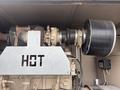 A Katolight SED60FPJ4 generator with a metal casing a turbocharger and a large exhaust pipe visible in the foreground