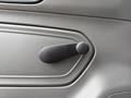 A black door handle control on the interior panel of a 2022 International MV607 vehicle
