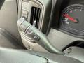 Close-up of a steering column control stalk from a 2024 Chevrolet Silverado 1500 featuring various functions for wipers and headlights