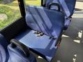 A blue upholstered seat with a seatbelt in a 2020 Chevrolet Express van interior