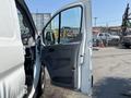 A 2019 Ford Transit 350 with an open side door revealing the interior space and a gray door panel designed for easy access and loading