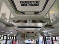 Interior view of a 2020 Chevrolet Express showing the ceiling with an emergency exit sign air vent and overhead lights