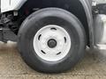 A close-up view of a large wheel with a white rim and black tire on a 2016 Freightliner 108SD truck