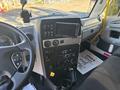 Dashboard of a 2022 Lion Lion6 featuring controls, a touchscreen display, and various gauges along with audio system buttons