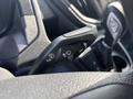 A close-up of the control stalk from a 2016 Ford Transit 150 featuring buttons for windshield wipers and headlights