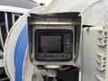 A close-up of a control monitor featuring buttons labeled F1 to F4 and an OK button, mounted on equipment associated with a 2013 International Workstar 7500