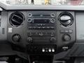 Dashboard of a 2015 Ford F-450 featuring air conditioning vents a digital display and various control buttons for audio and climate settings